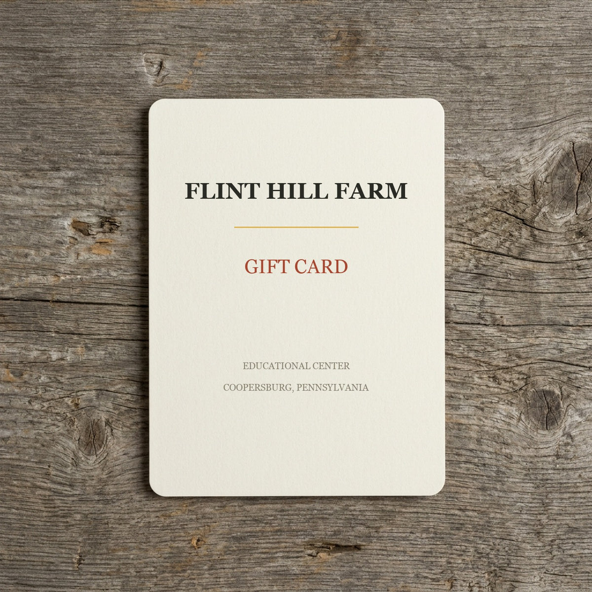 Flint Hill Farm gift card on a weathered barn-wood table