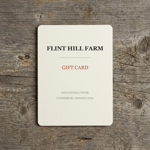Flint Hill Farm gift card on a weathered barn-wood table