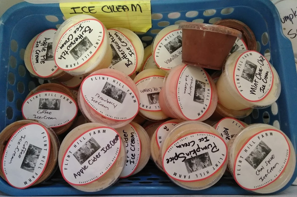 Tubs of Flint Hill Farm ice cream in a basket, each labeled with its flavor