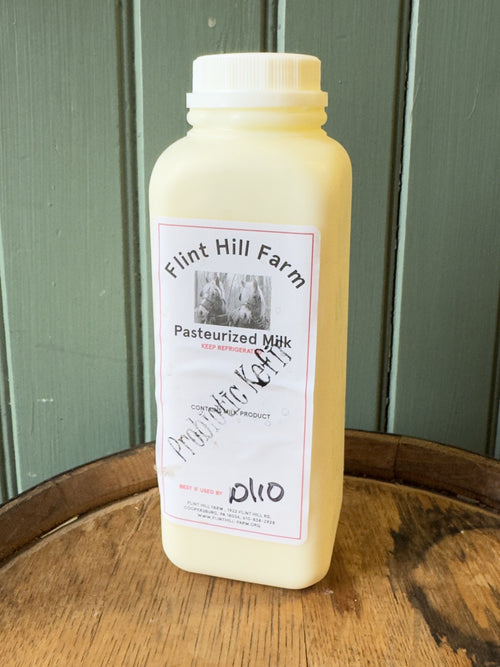 Pint of Flint Hill Farm probiotic kefir on a wooden barrel