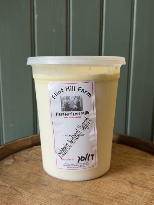 Quart of Flint Hill Farm probiotic natural yogurt on a wooden barrel
