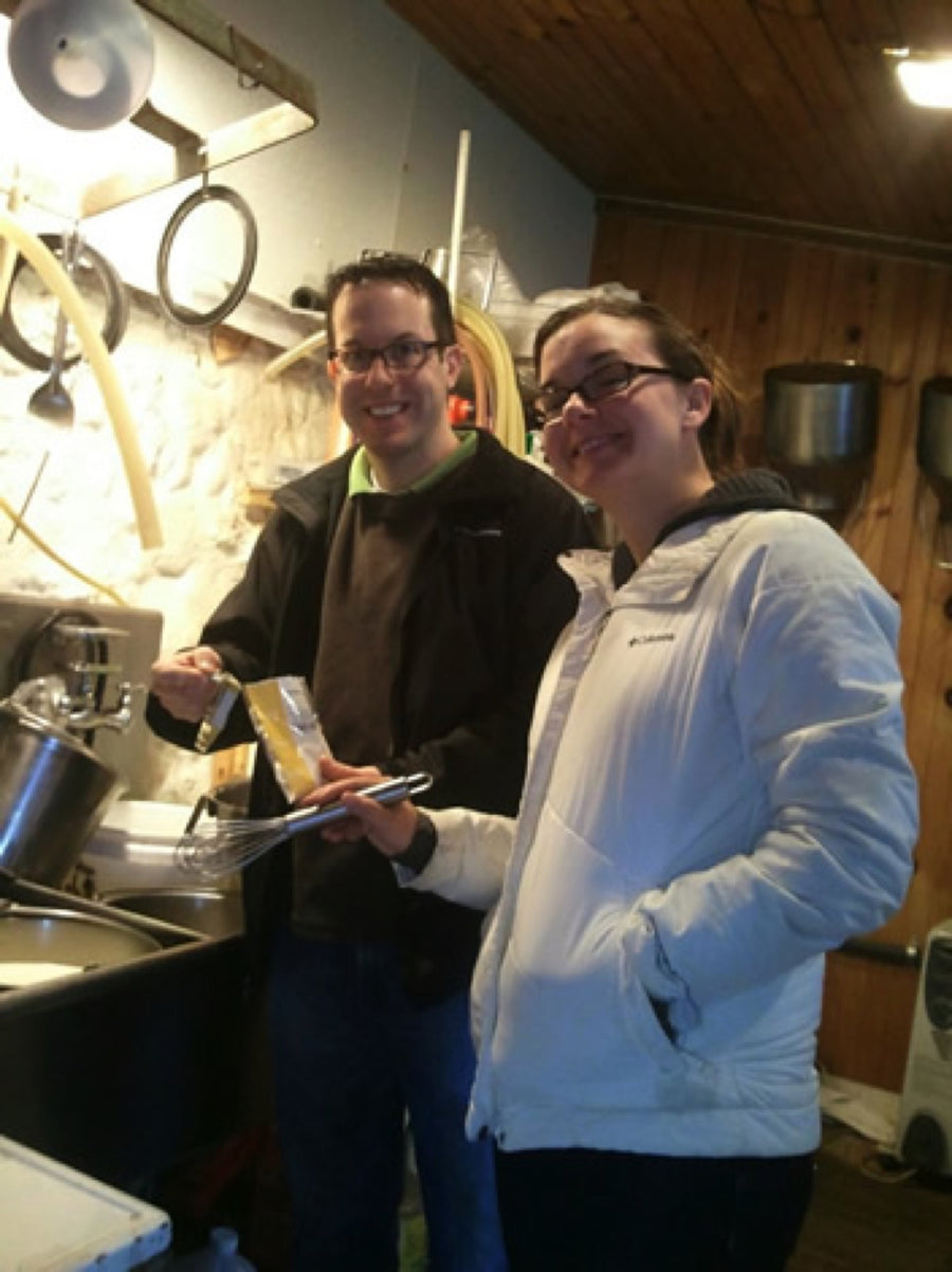 Students working together at a cheese-making class table