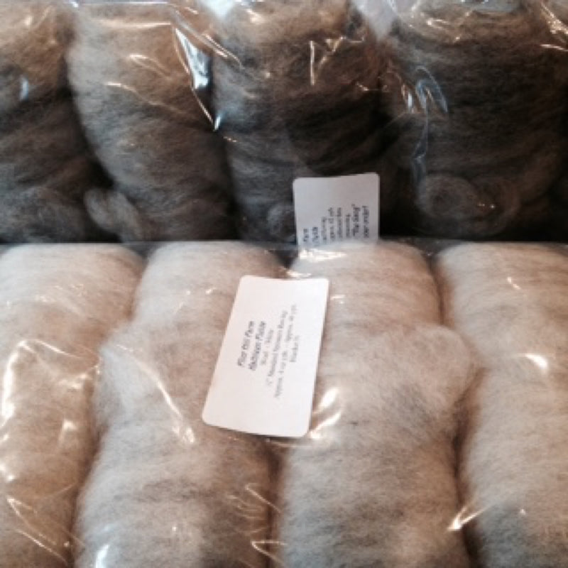 Bags of natural-color wool roving in black, brown, tan, and gray