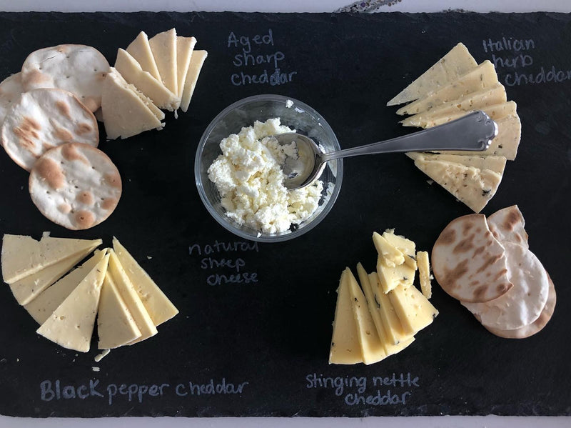 Cheese tasting spread on a slate board