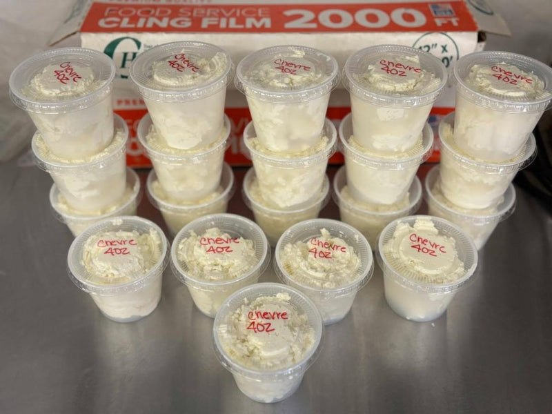 Cups of fresh chèvre, labeled and ready for the store