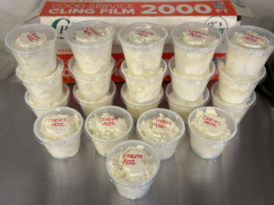 Cups of fresh chèvre, labeled and ready for the store